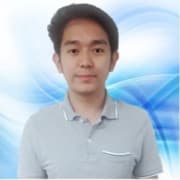 A young man wearing a light blue collared short sleeve shirt with a blue and white abstract background