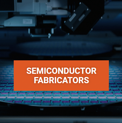 A blue semiconductor wafer disc at a low angle and several of the chips are visible with the text overlay 'SemiconductorFabricators'